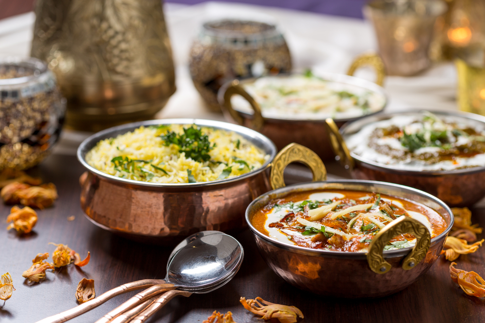 Indian curries in brass bowls