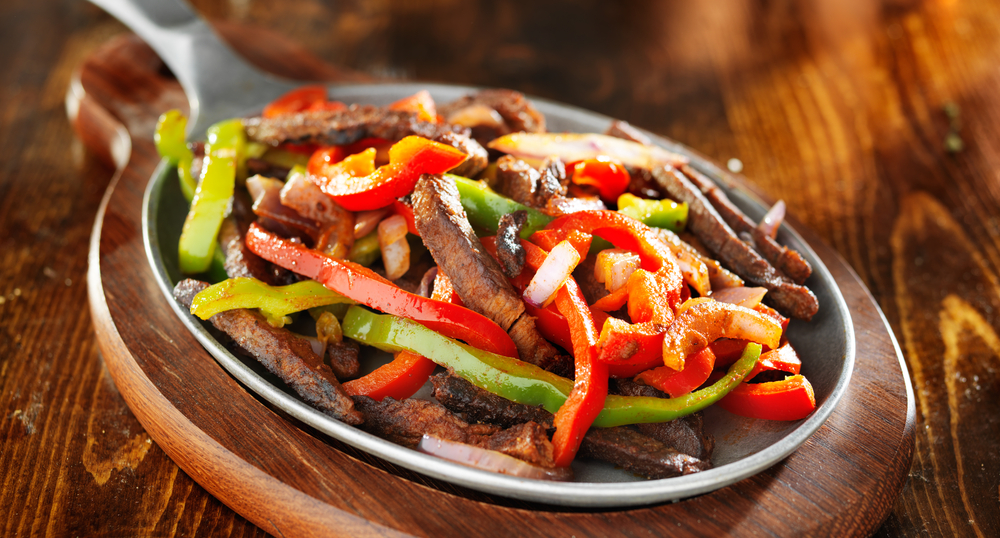 mexican beef fajitas with bell peppers panoramic shot