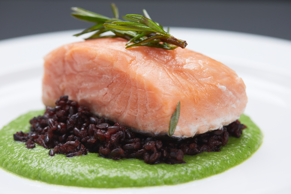 What is Sous Vide? 
Pink fish on black rice and green puree
